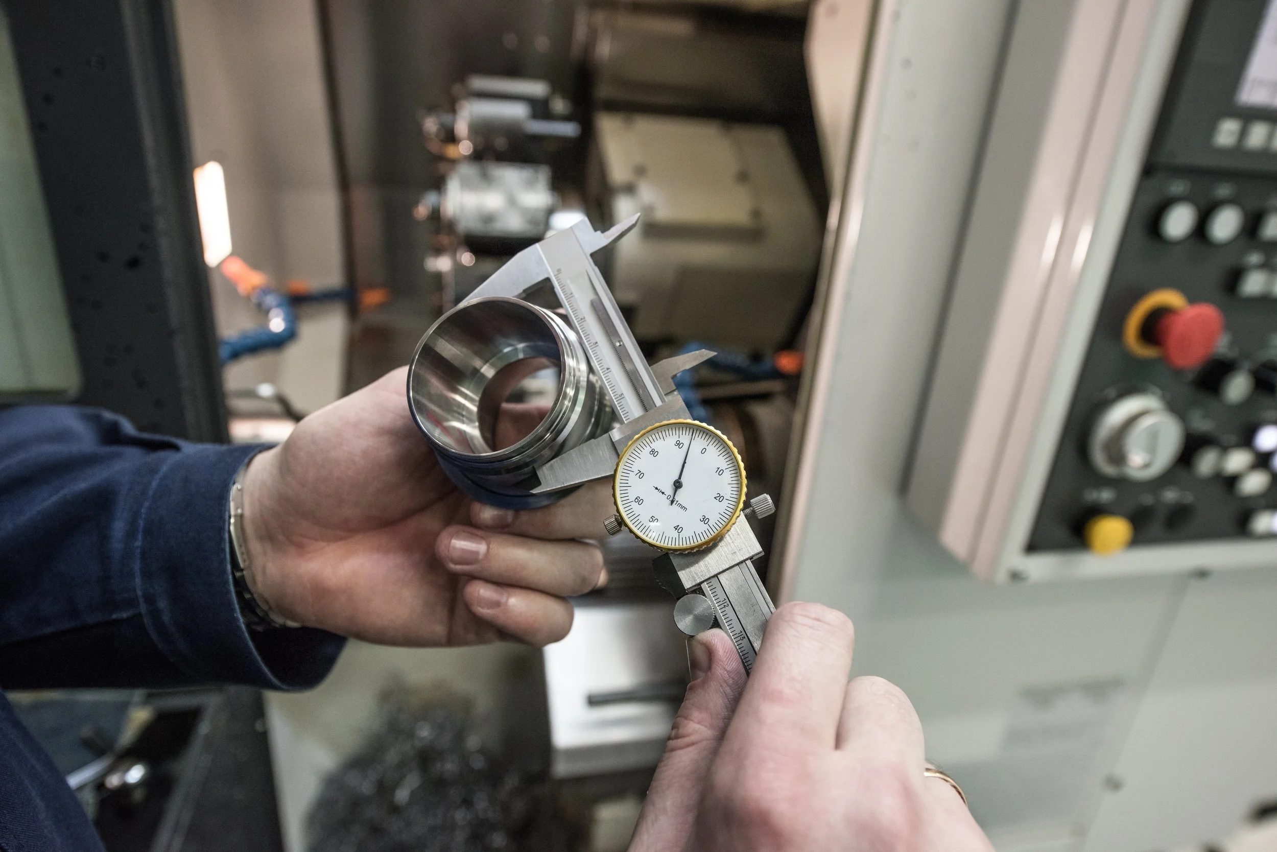 checking accuracy cnc lathe in background.jpg