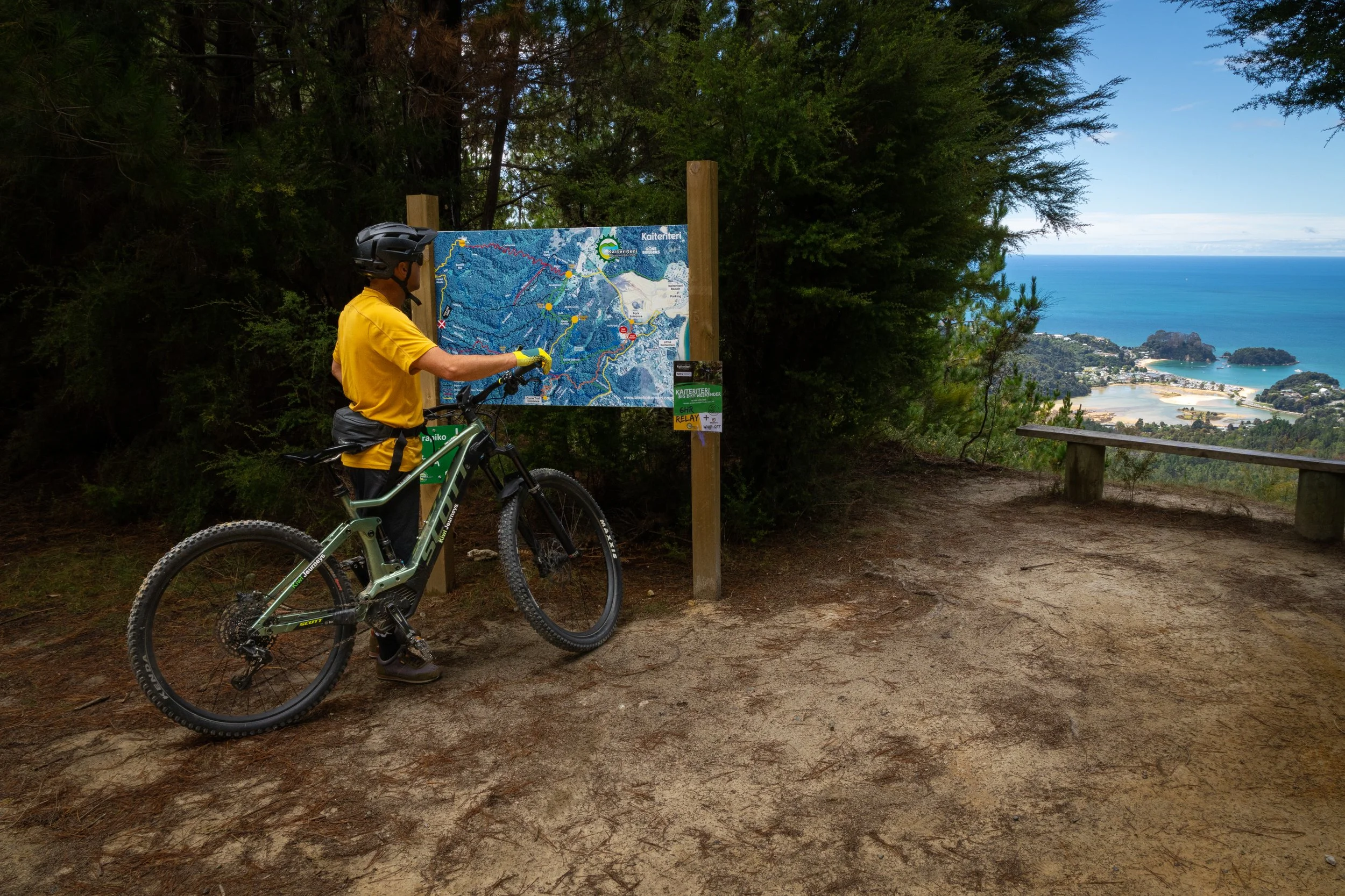 Mountain biker looking at bike tracks at Kaiterteri Mountain bike park