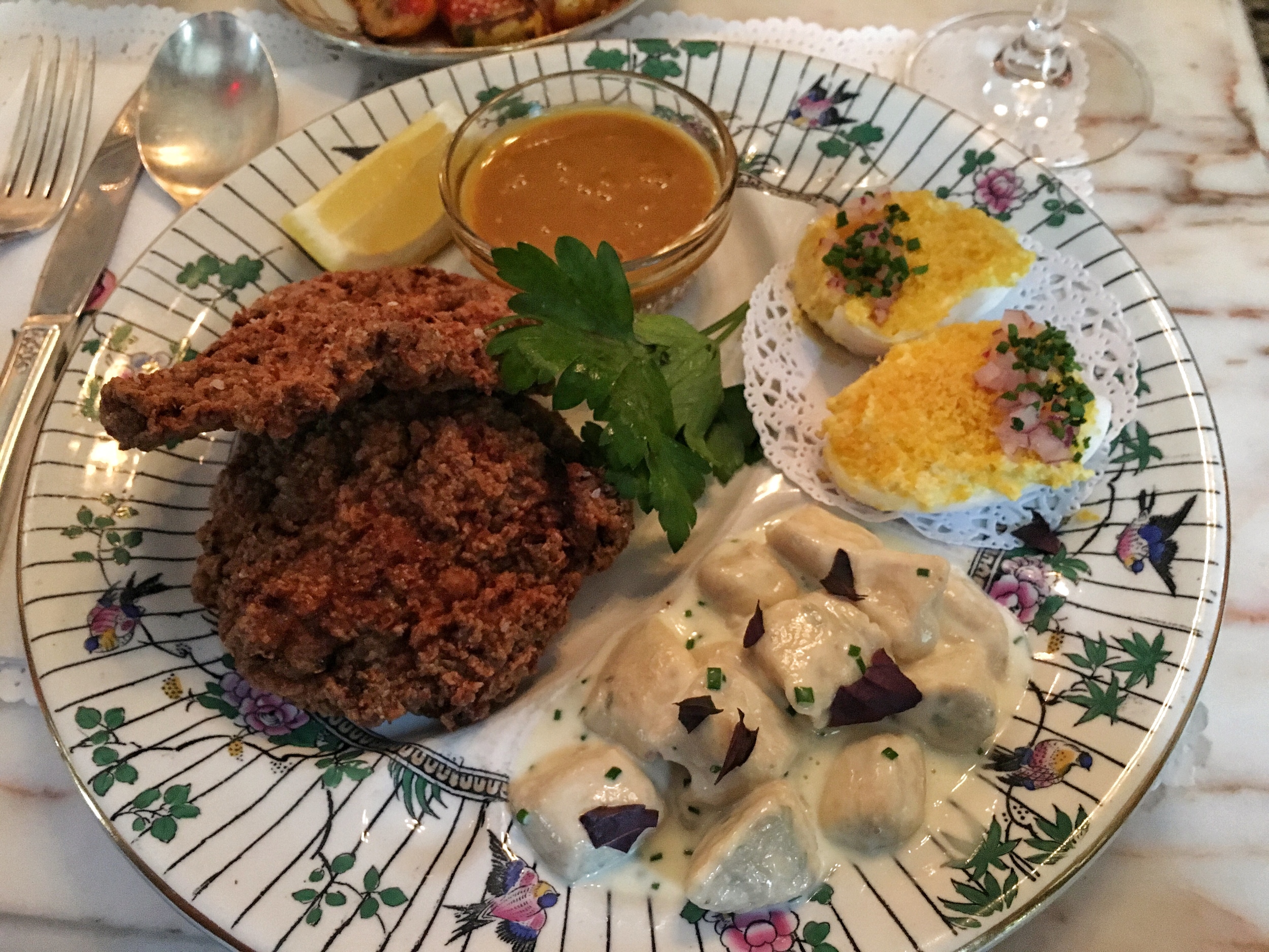 Chicken fried pork cheeks in honey mustard seed sauce, ricotta gnocchi, deviled duck eggs