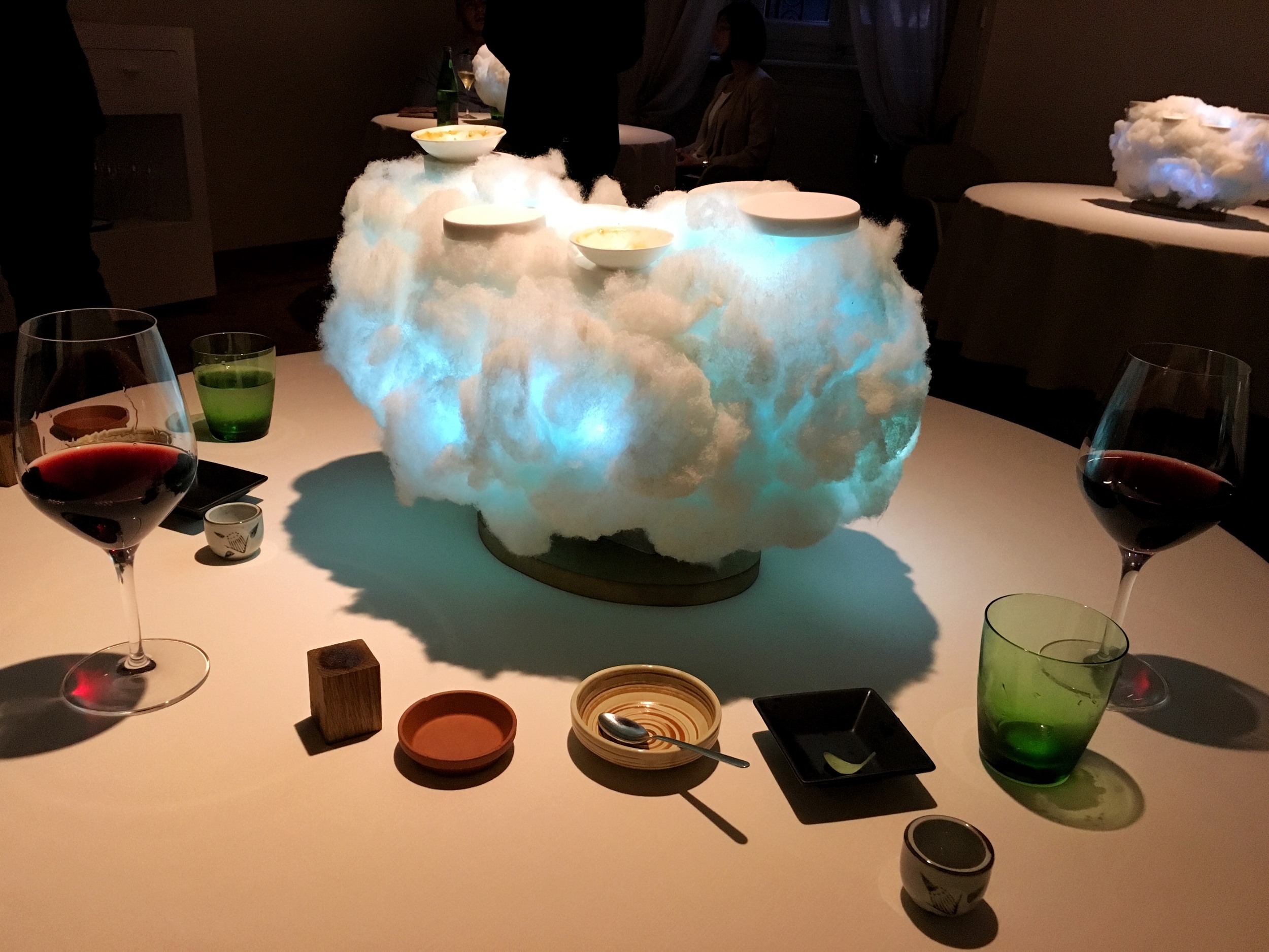Amuse bouche comes in a neon lit cloud with olives, smoked fish and cheese.
