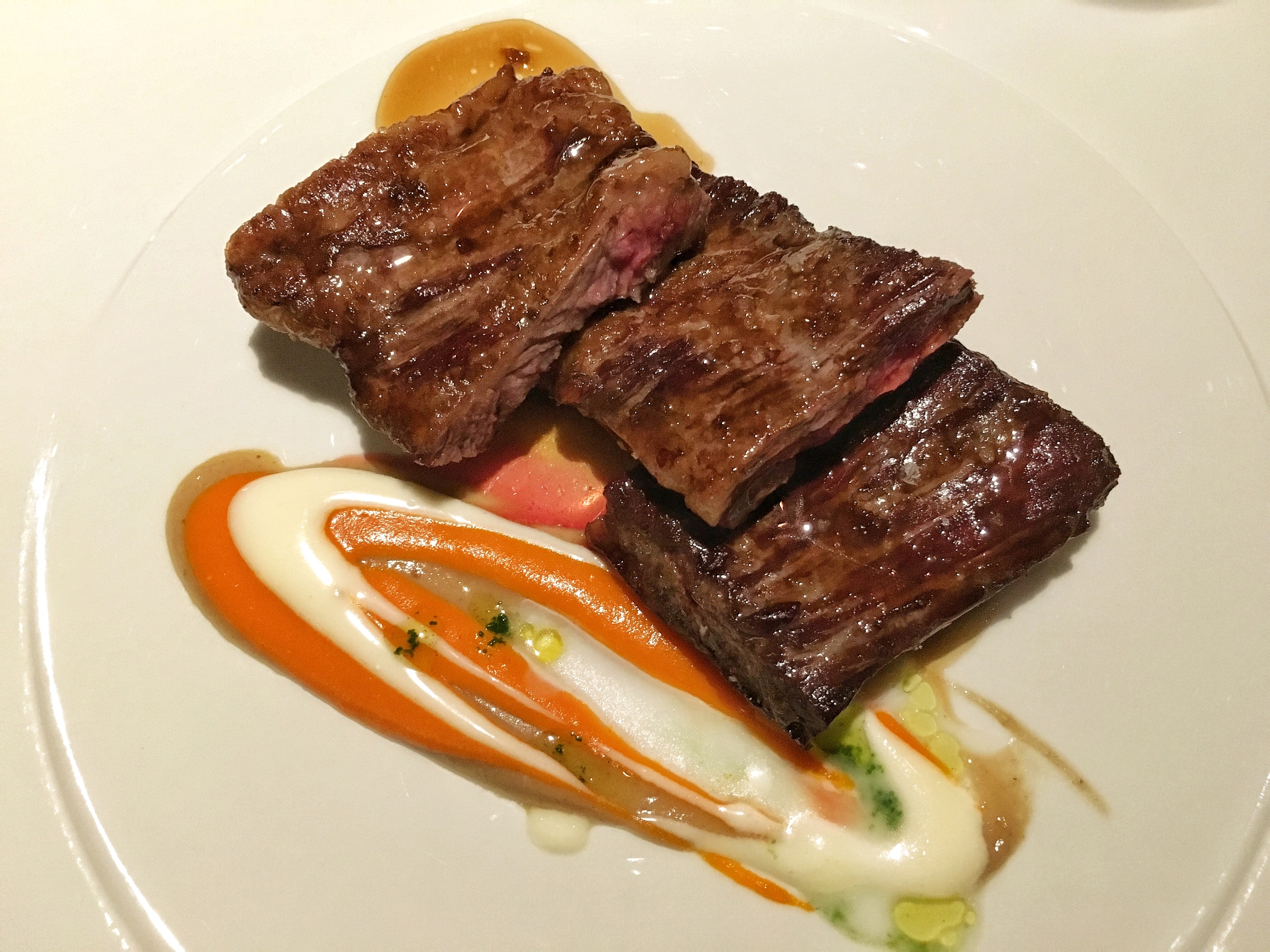 Cow stomach with carrot puree and tomatillo sauce