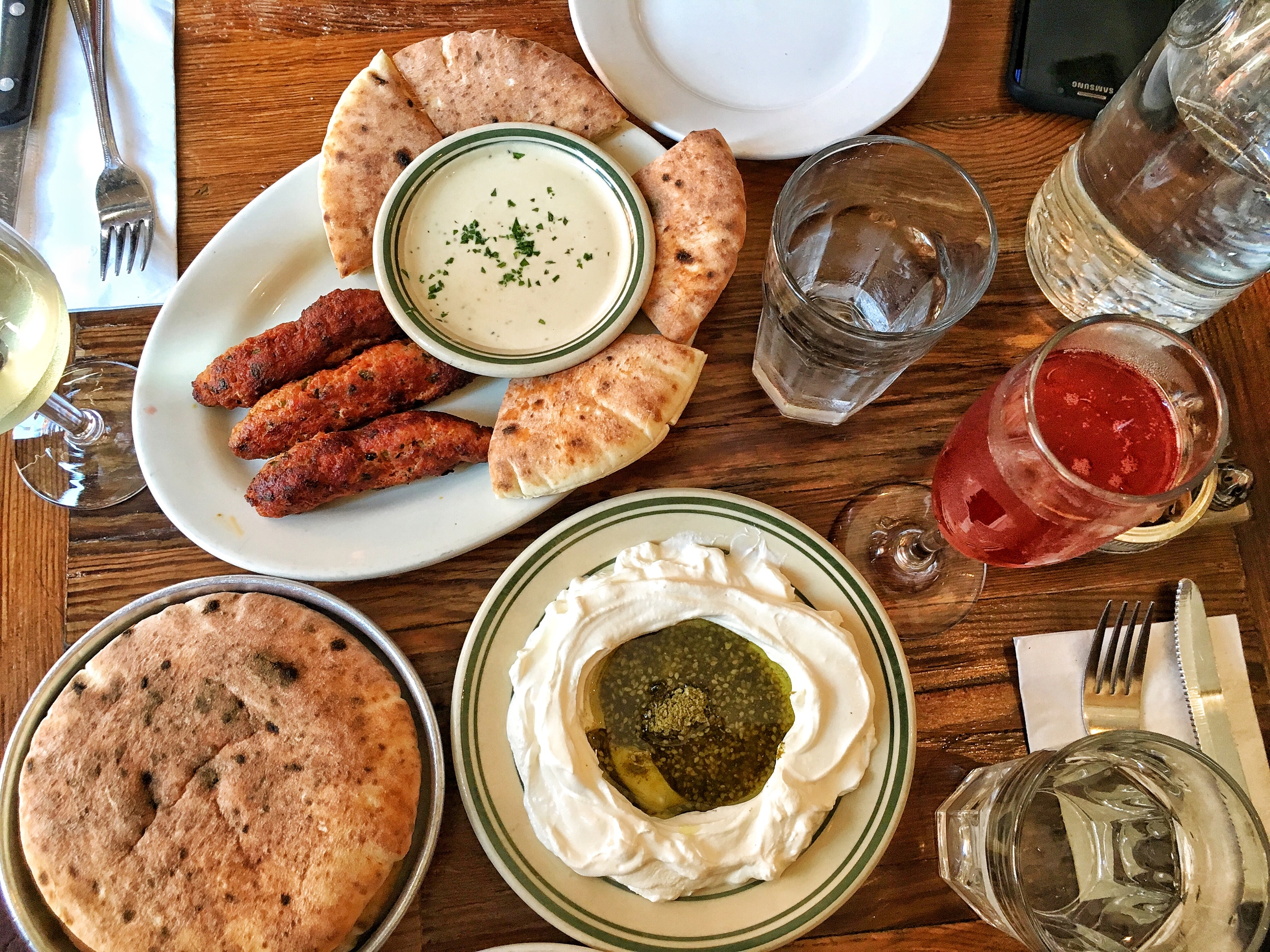Labneh, warm freshly baked pita bread, lamb kebabs with tahini and pita, chardonnay, pomegranate mimosa