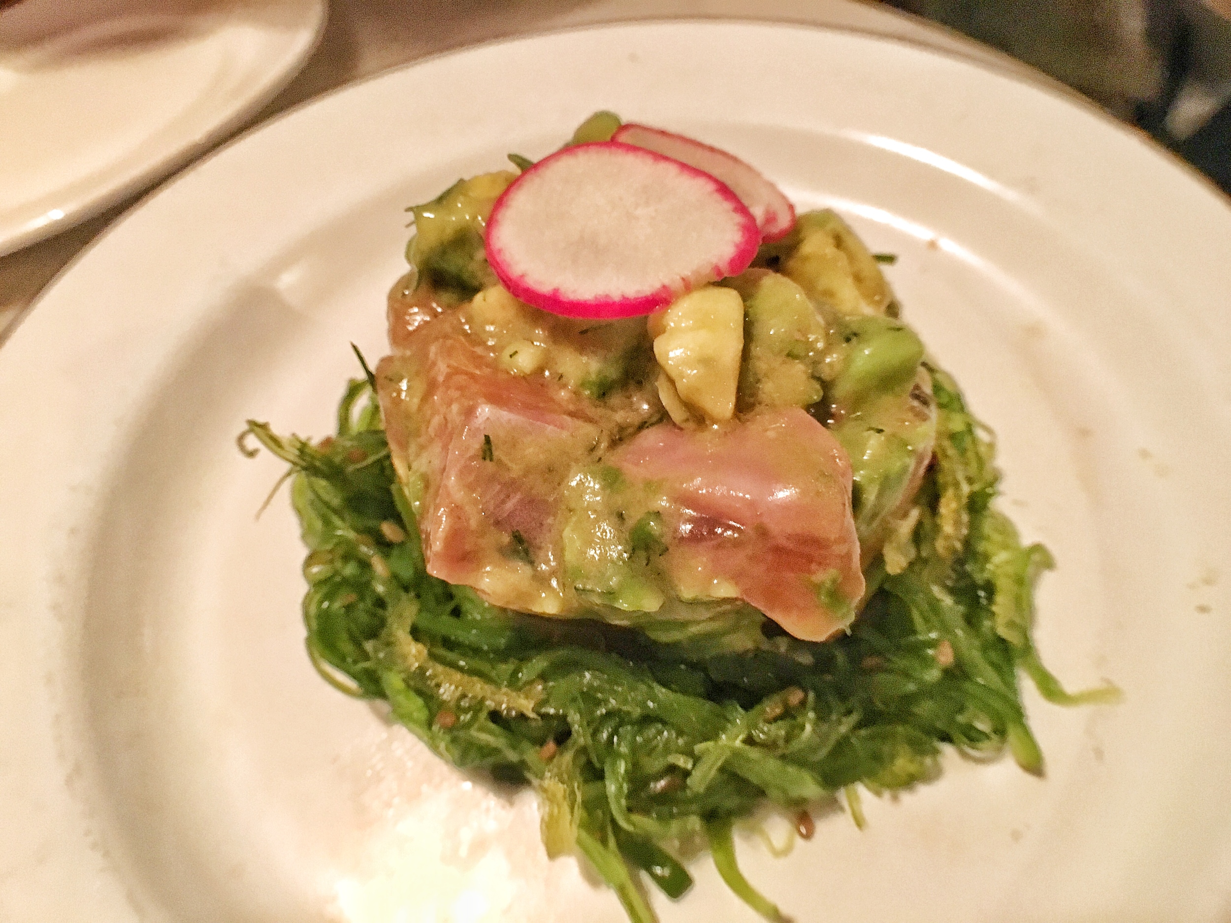 Salmon poke on avocado and seaweed