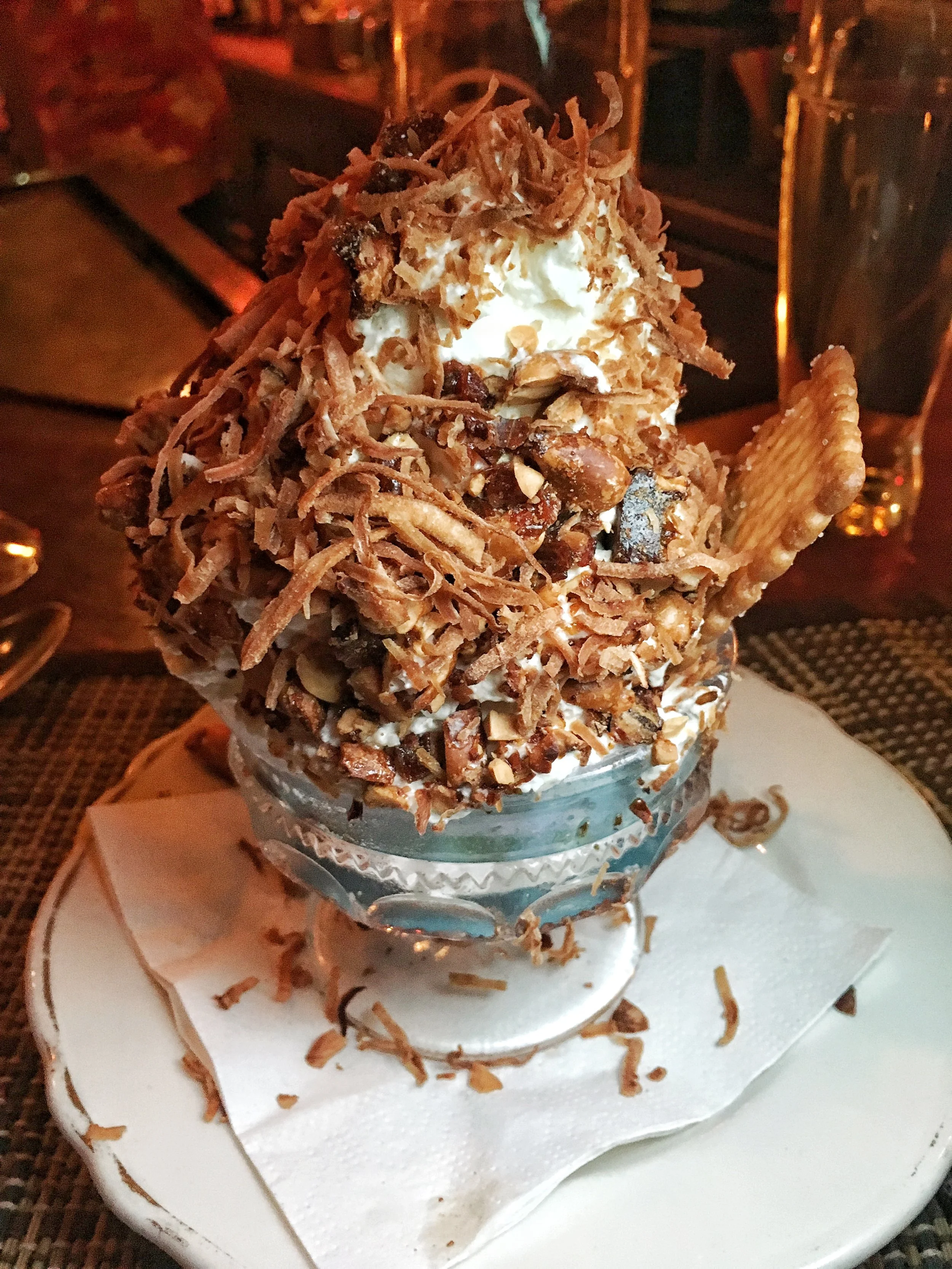 Coconut ice cream with roasted coconut flakes and roasted peanuts