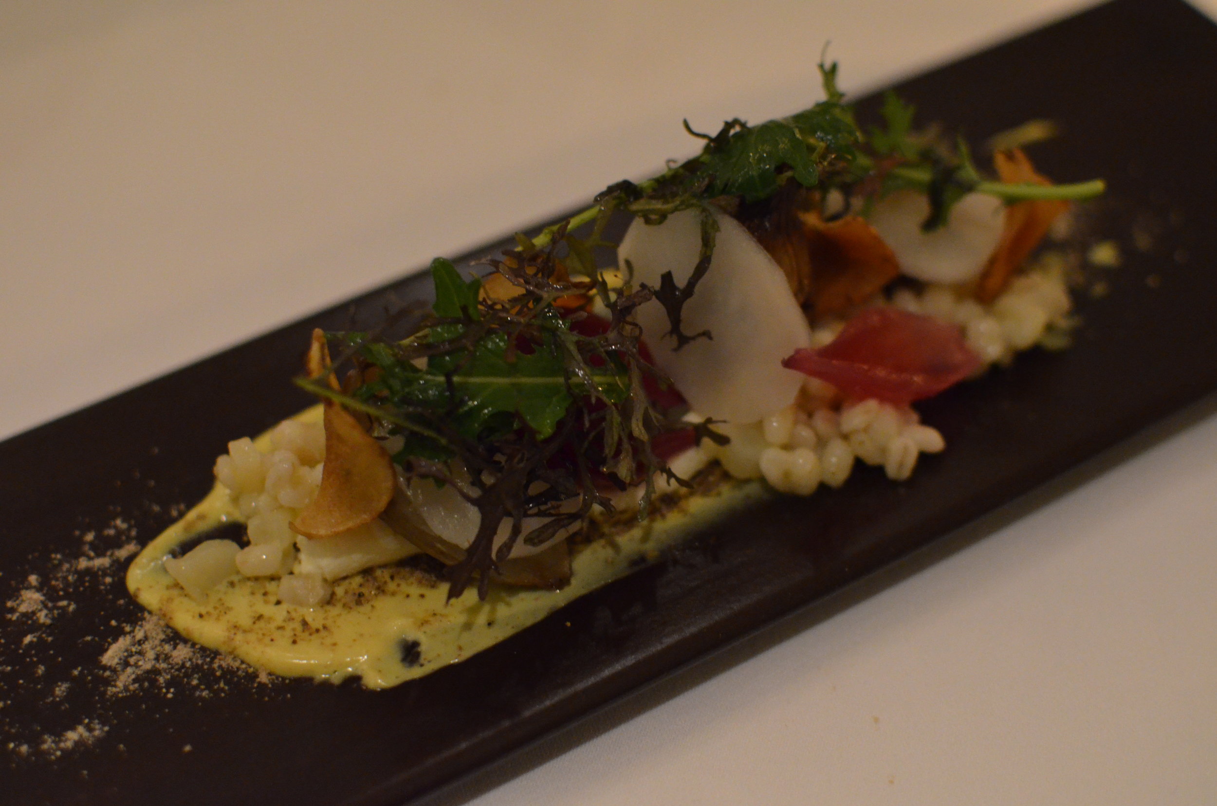 Salad of jerusalem artichoke, homemade fresh cheese and roasted red onion