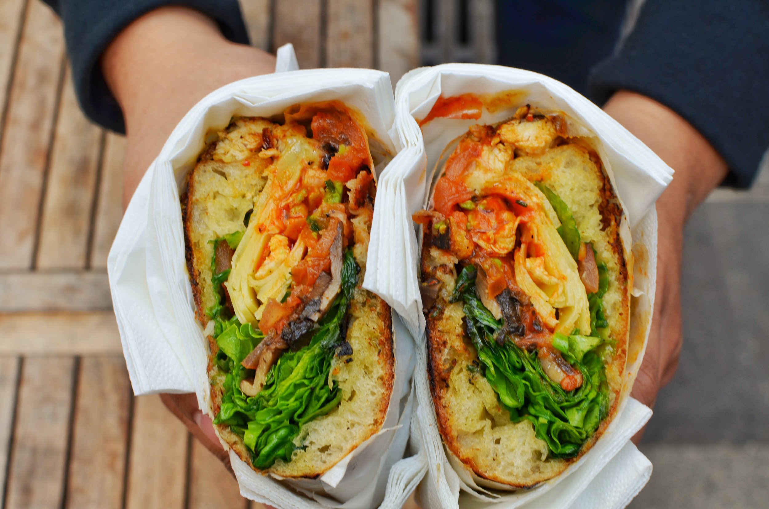 Chez Alain Miam Miam- Spicy chicken sandwich with comté cheese, tomatoes, avocado, lettuce, mushrooms and onions