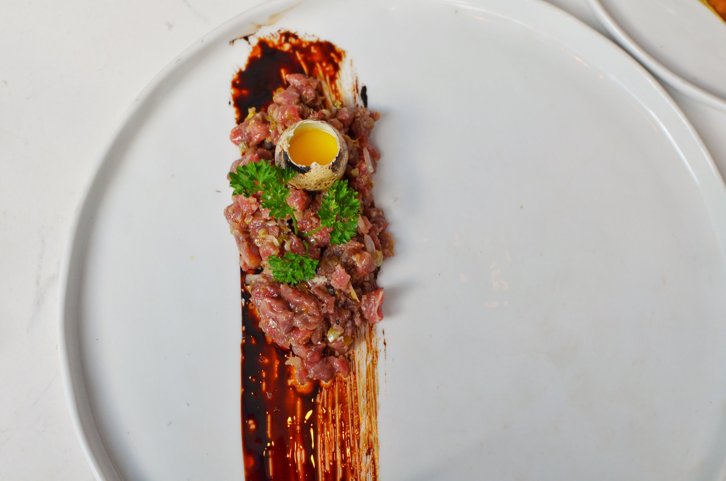 Beef Tartare, quail egg, cornichons
