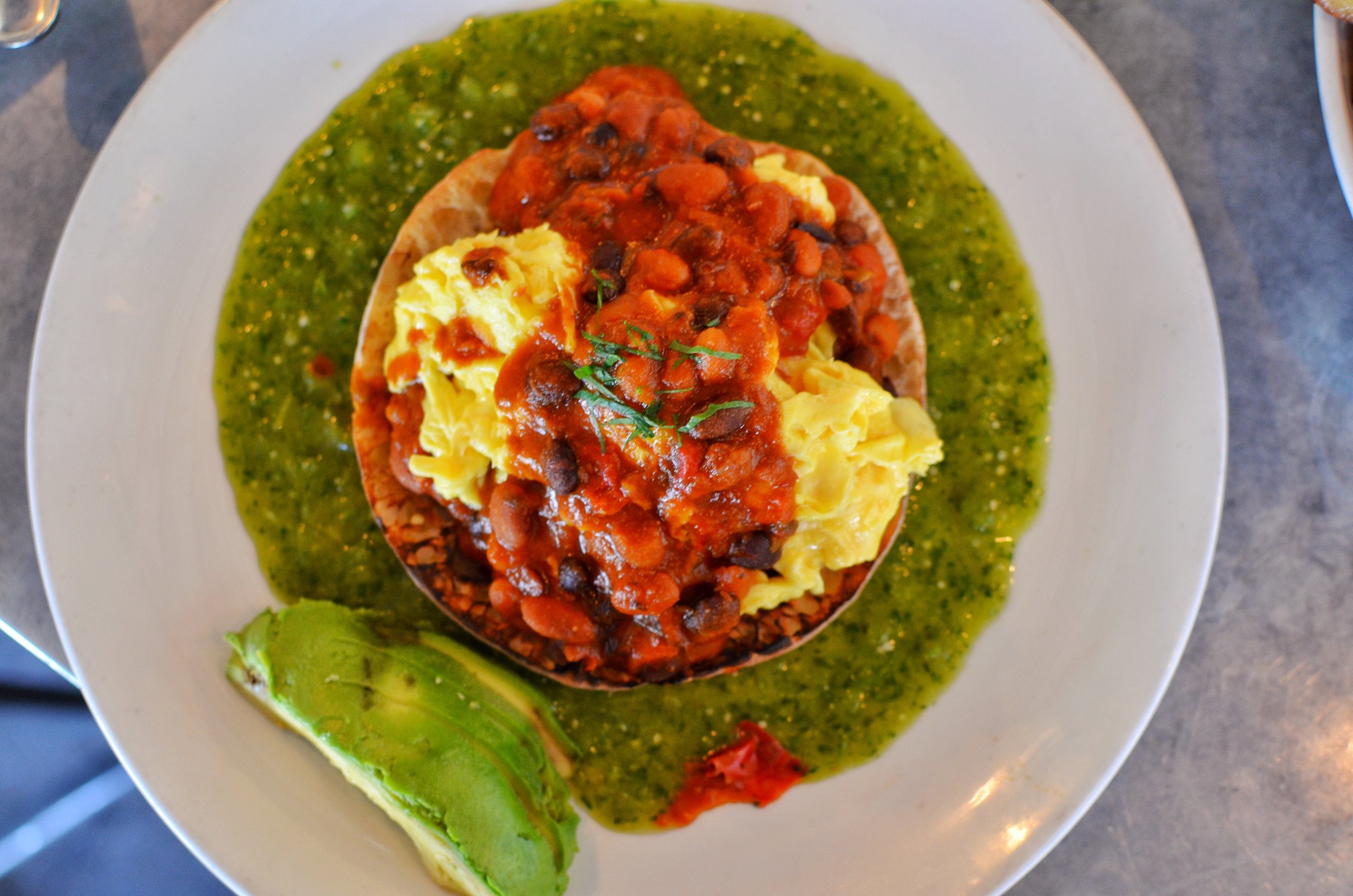 Virage Rancheros- 2 eggs, red & black beans, matbucha, salsa verde, pita