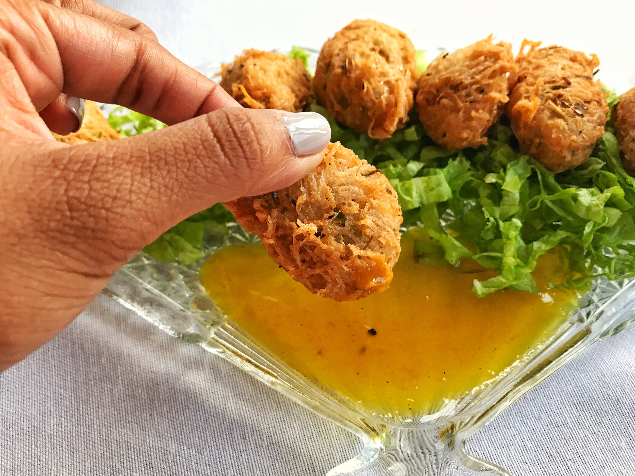 Mixed seafood fritters with a citrus glaze sauce for dipping