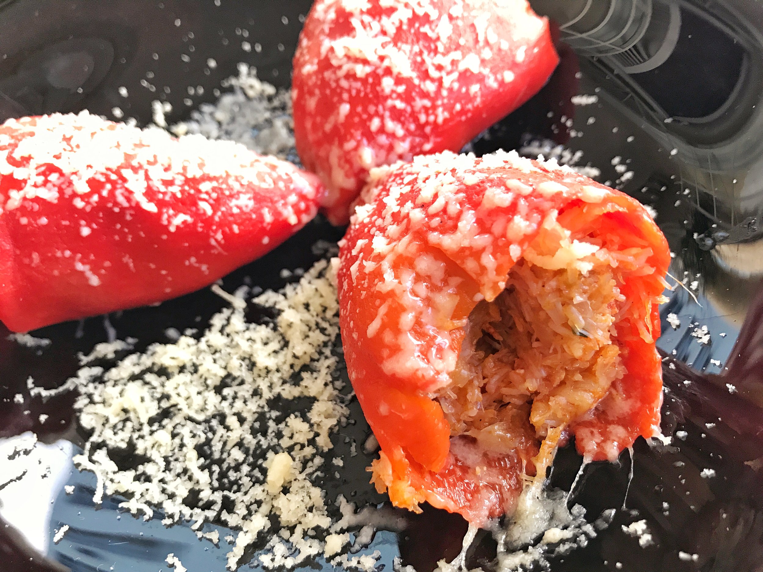 Roasted bell peppers stuffed with crab topped with parmesan cheese