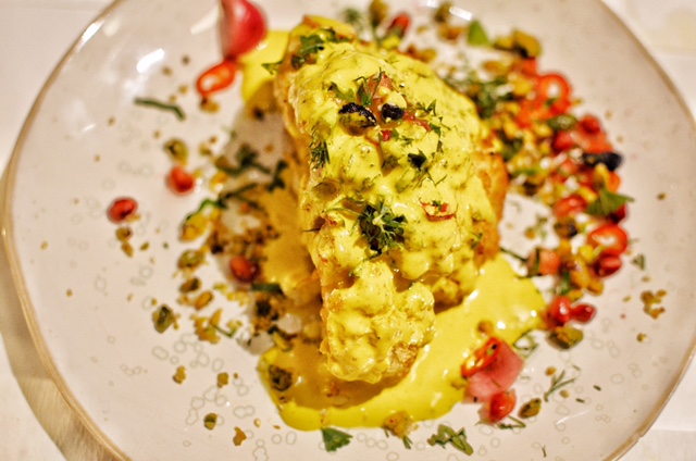 Half cauliflower, with turmeric-tahini and pistachios