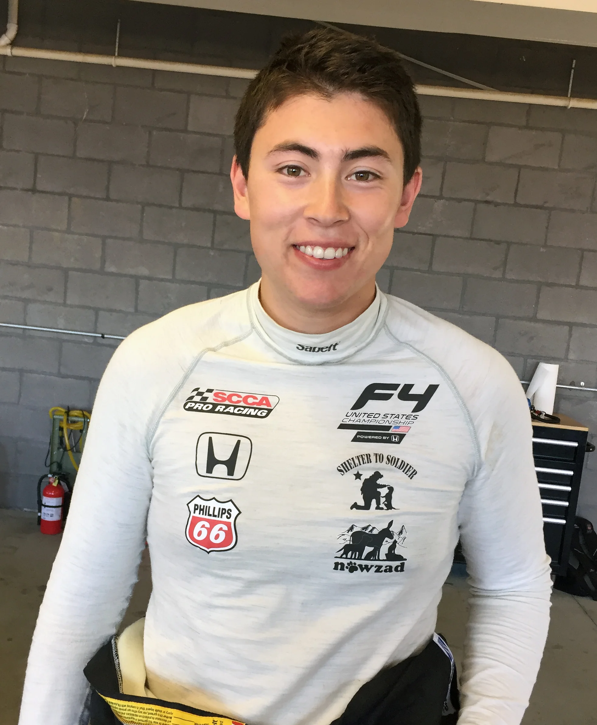Dakota proudly wears the logos of his two favorite charities.