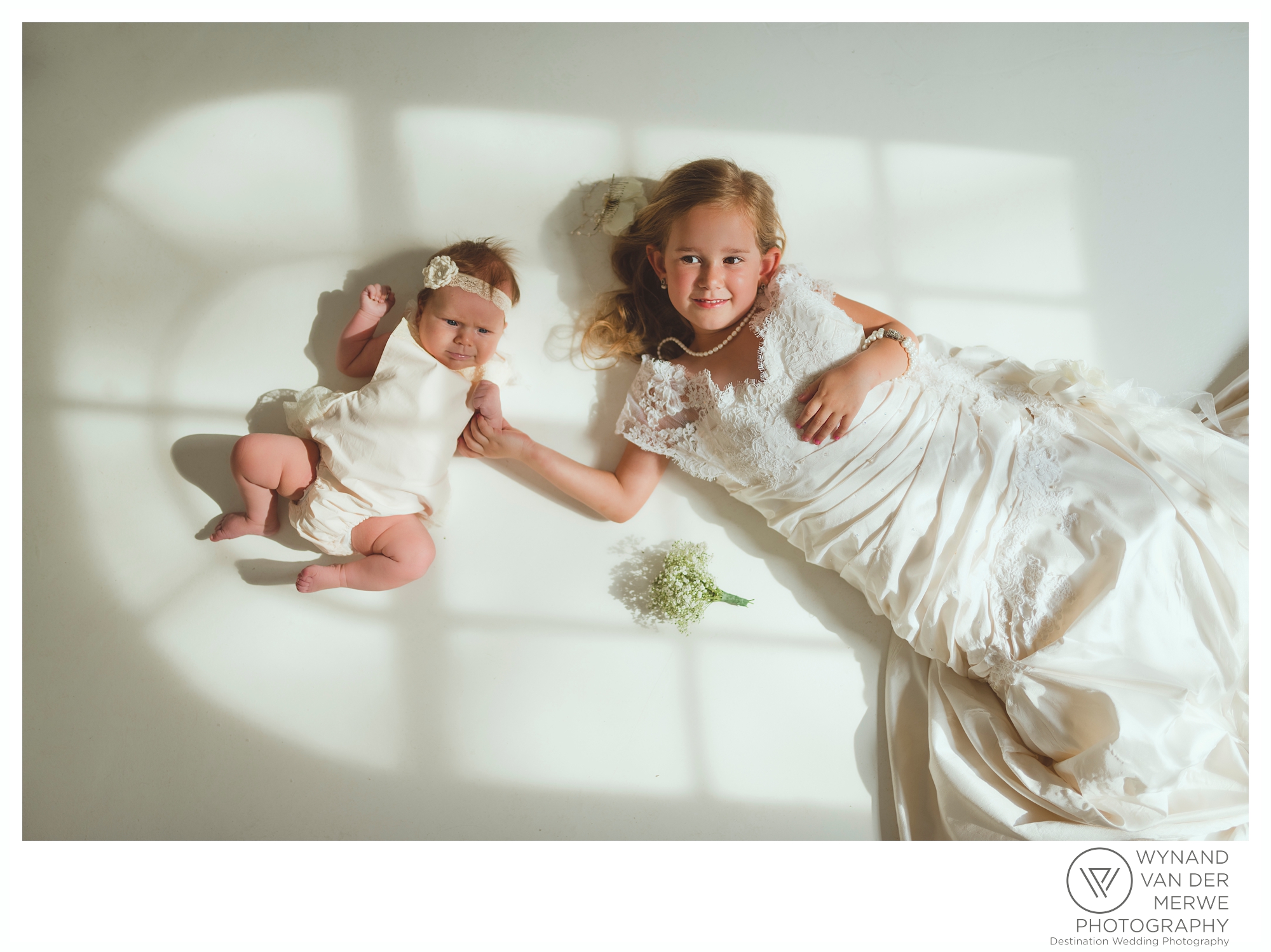 A little girl in her mom's wedding dress