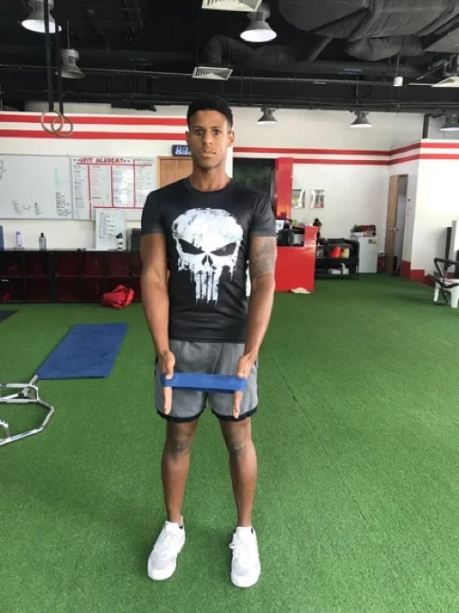 1. Hold a resistance band around your hands.