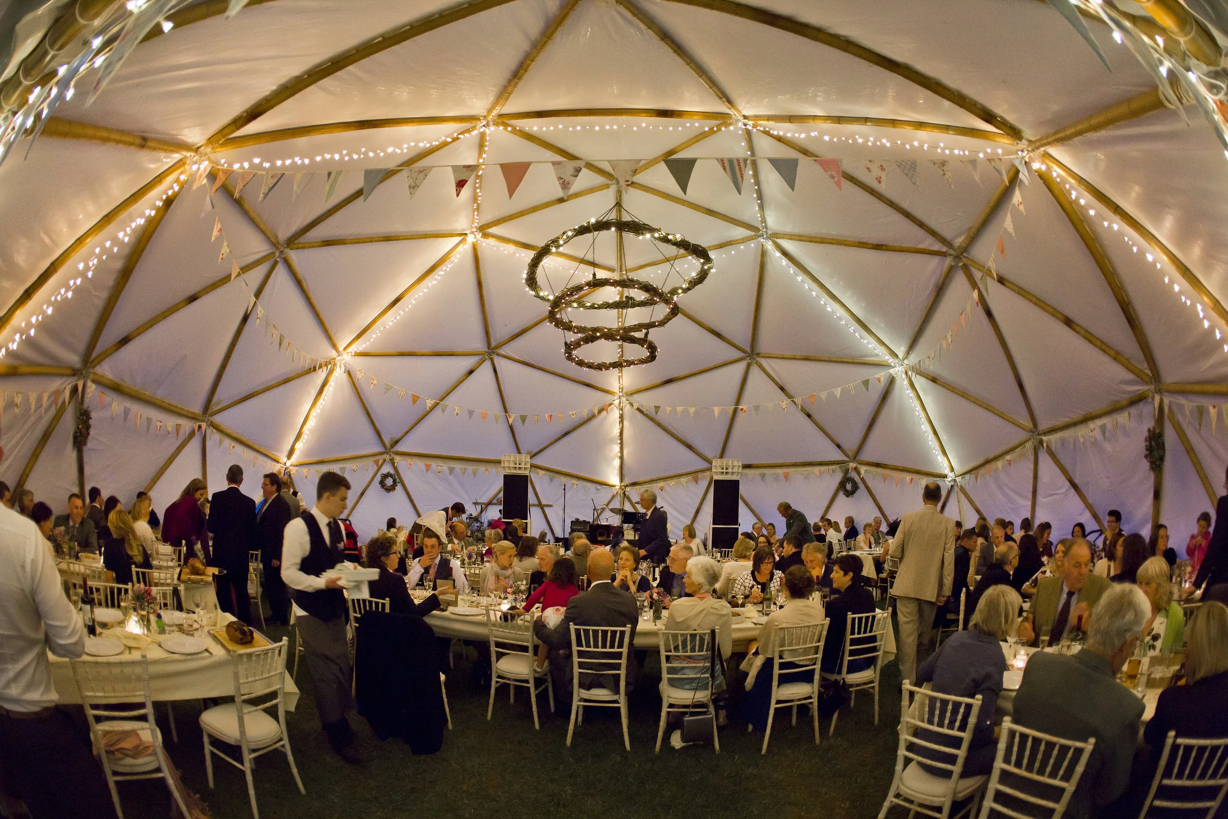 Bamboo geodome wedding seated for a meal