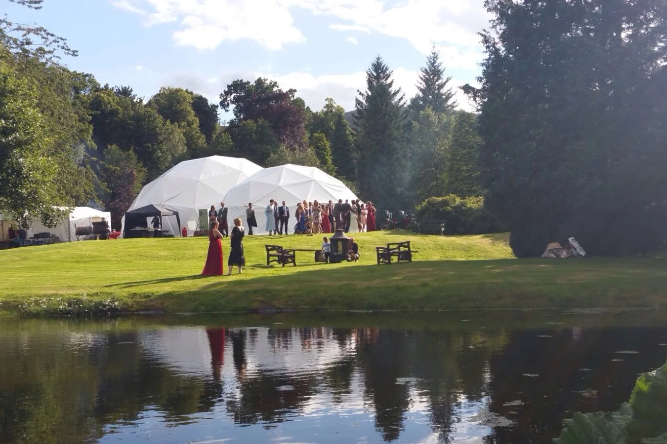 Exterior view of Atlas Domes geodomes being used for a party.