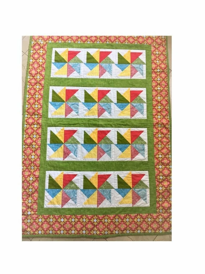 The beautiful pinwheel quilt. My Mom's handy work. Thank you Nana!