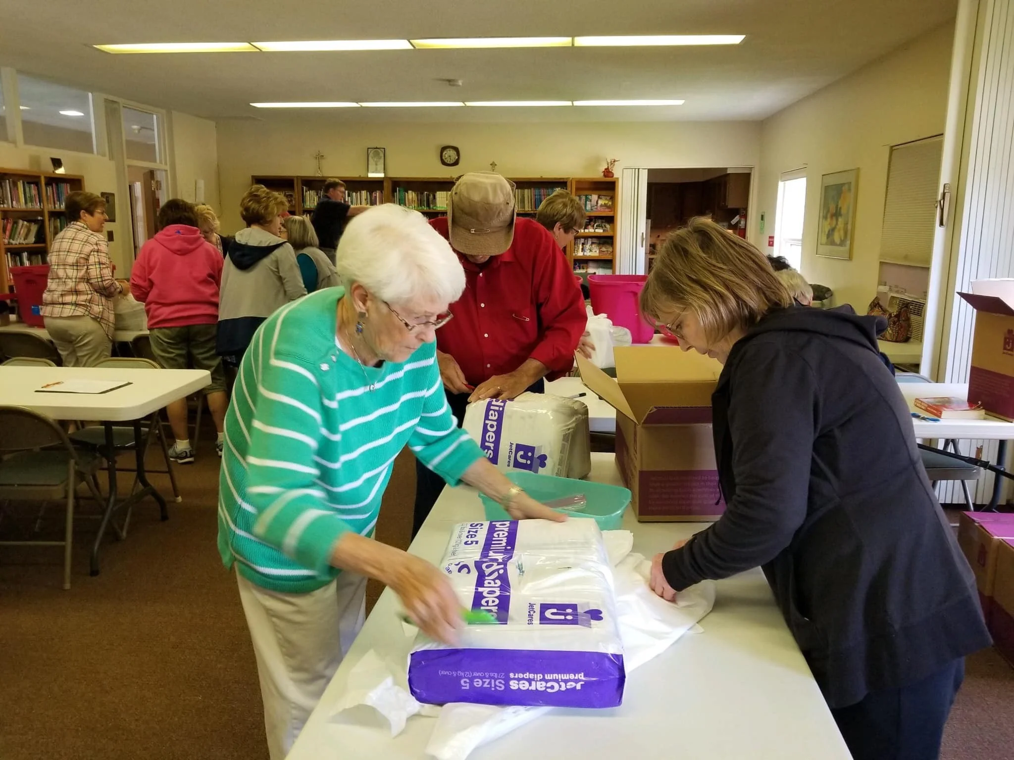 Volunteers assist in packing diapers for Isabella County families in need.