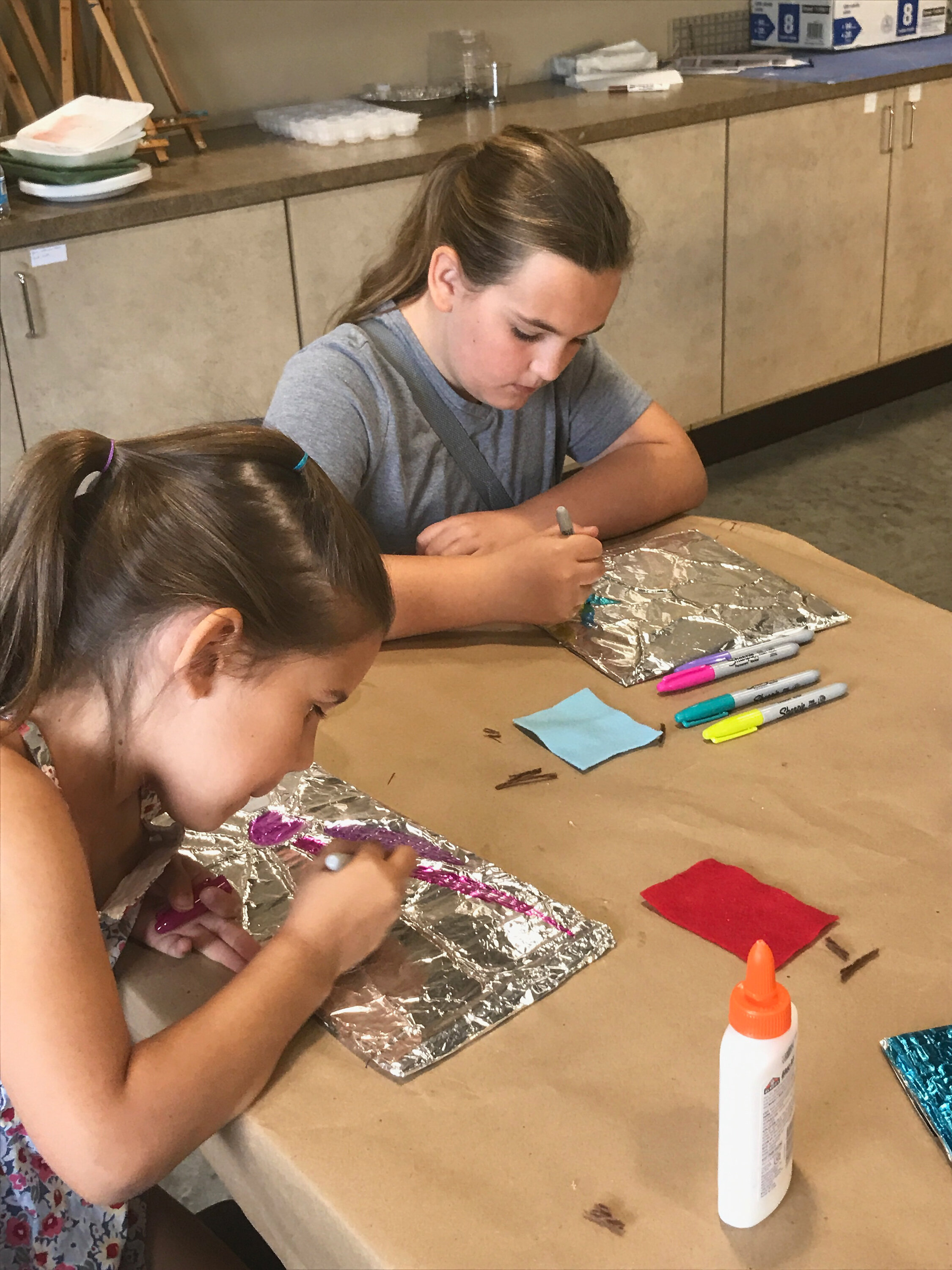 Two girls coloring and taking part in Art Walk Central