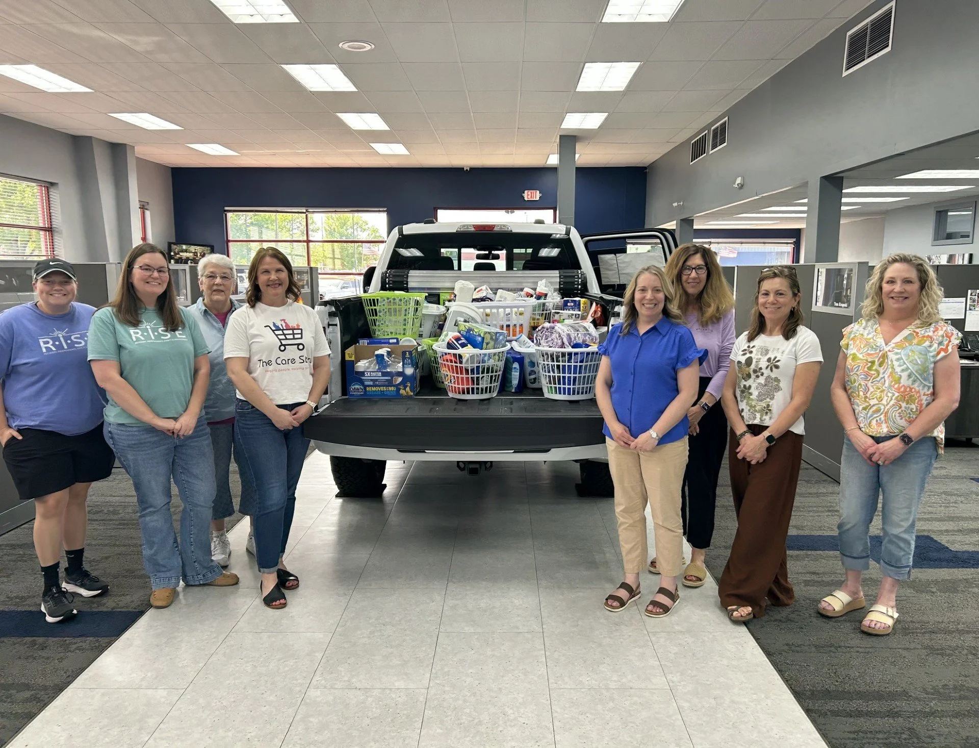 Members from Women's Initiative, RISE Advocacy and The Care Store gather at Krapohl Ford to pick up donations for Kay's Way.