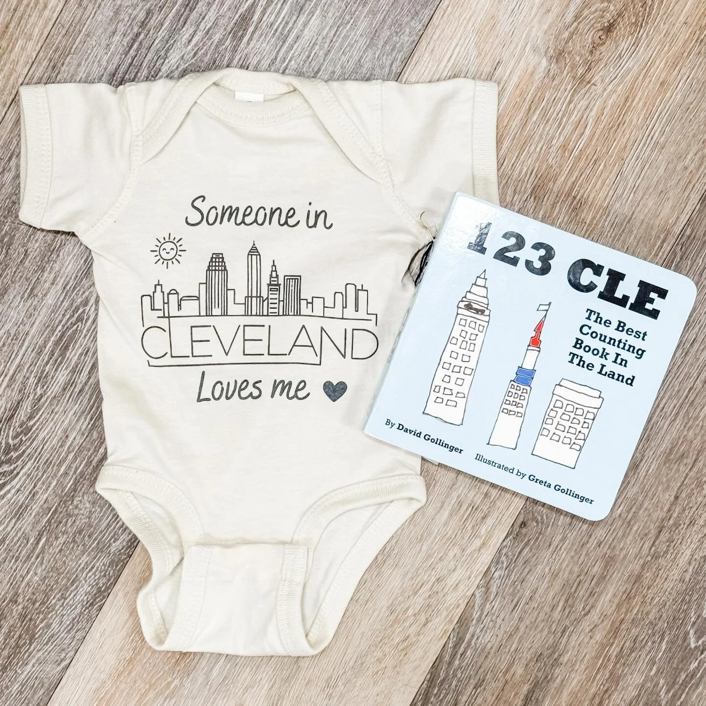 Our adorable onesie from @lakesidelocalsapparel paired with this sweet book from @clekidsbooks is a perfect gift for your out-of-state little loves ❤️👶🏼🎁