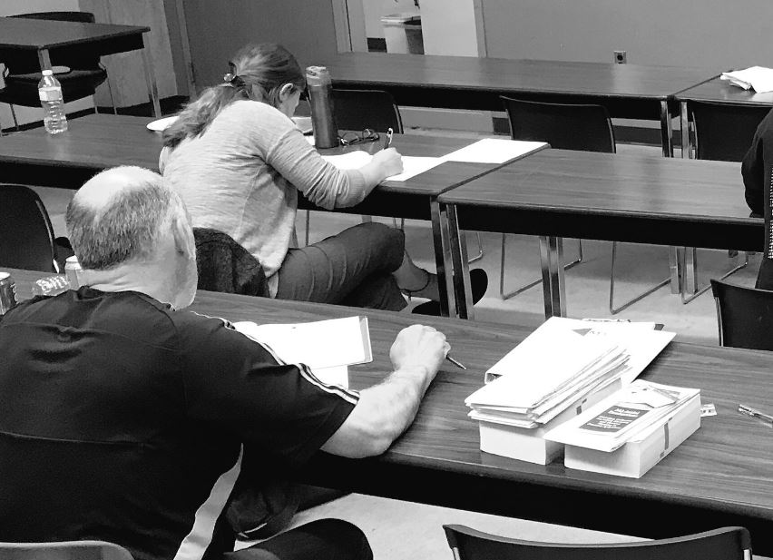 Students completing the final written exam after the 16-hour, 2-day UAV Ground School Course offered by M3 Aerial Productions. 