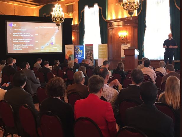 Matthew Johnson, President of M3 Aerial Productions, speaks to a packed room at the Fort Garry Hotel in Winnipeg about Drone Training and the M3 Aerial Network.