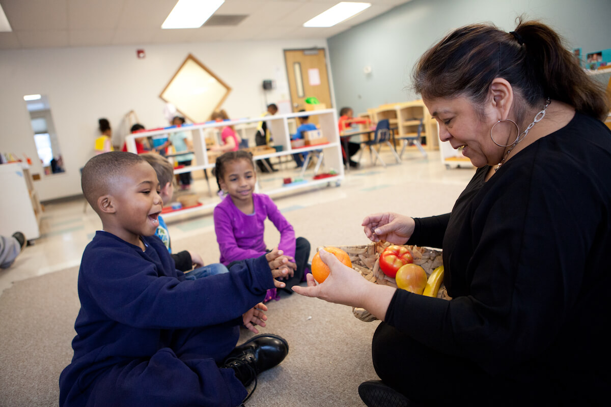 Miss Julia interacts with an MLK Montessori student. Miss Stacey is pictured at the top of the article.