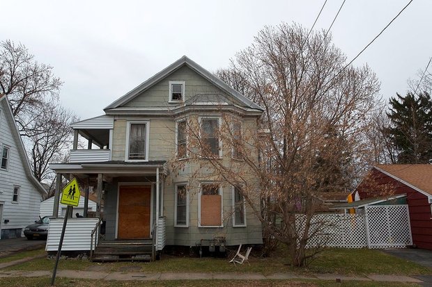 A vacant home owned by the Syracuse Landbank at 301 Loomis Ave. will have its window boards painted by local students as part of a city-wide art project the Landbank is beginning. (provided by Logan Reidsma)