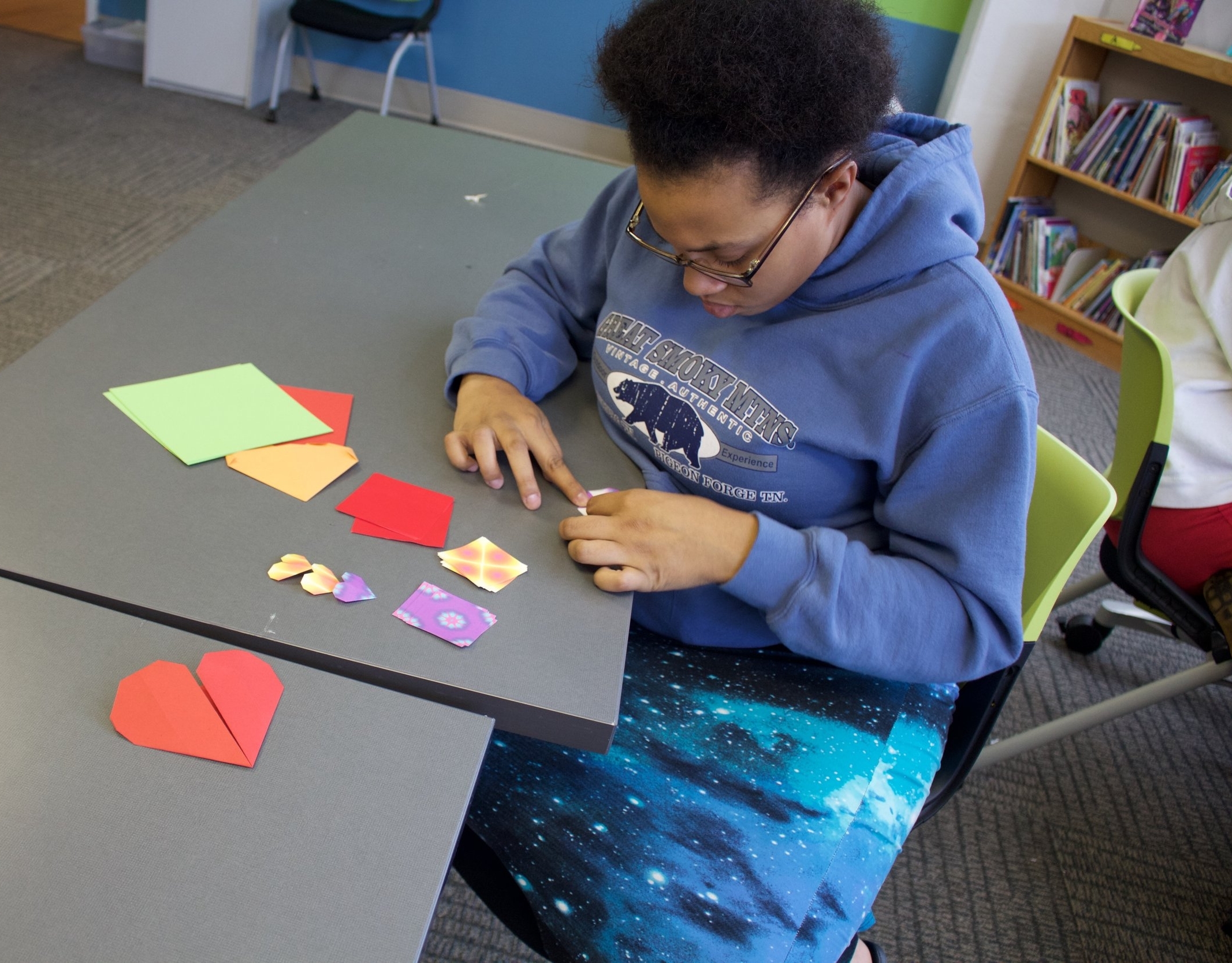 Family Care Center student making individual hearts for group project after KidsArt4Hearts lesson.