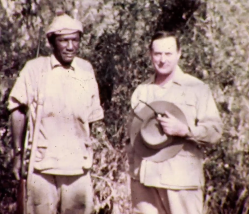 John Alexander (J.A.) Hunter, grandfather of Alex Hunter, posing with a member of the camp staff during the 1937 Sykes safari