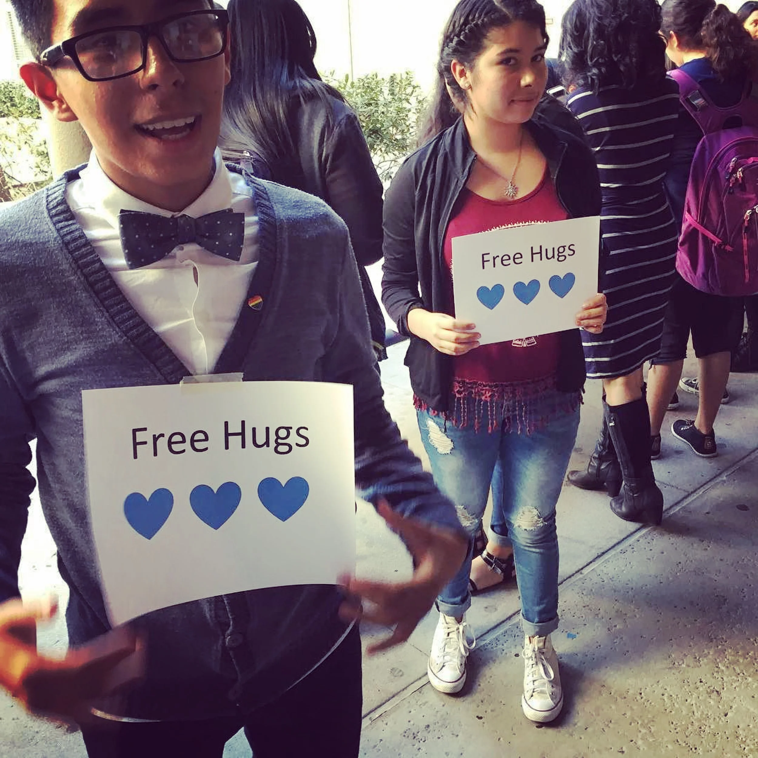 Humanitas Academy of Art & Technology (HAAT) students from Esteban E. Torres High School offer free hugs post-election. Photo by: @haatofficial