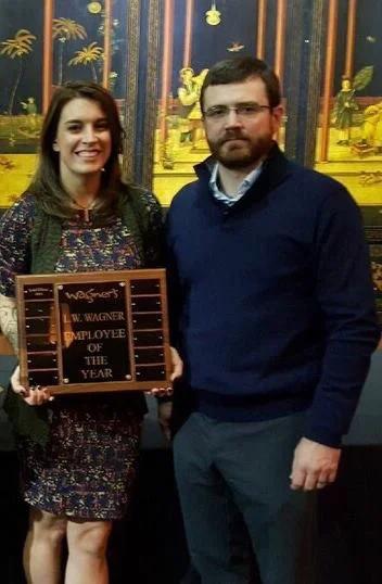 Arsenault stands with her boss and owner of Wagner’s RunWalk, Matt Wagner, during a store Christmas party.