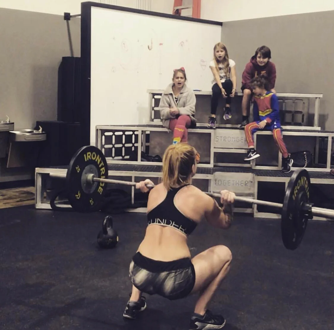 Arsenault’s children cheer her on as she workout at Irontribe in Tuscaloosa.