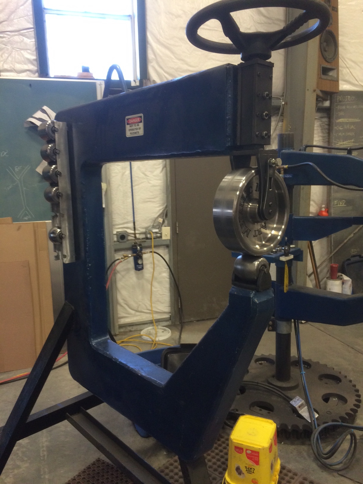 This is my english wheel. It has Hoosier Profiles wheels and adjusters. It was drawn up by myself and cut from AR 400 steel. It is exceedingly stiff and very smooth.