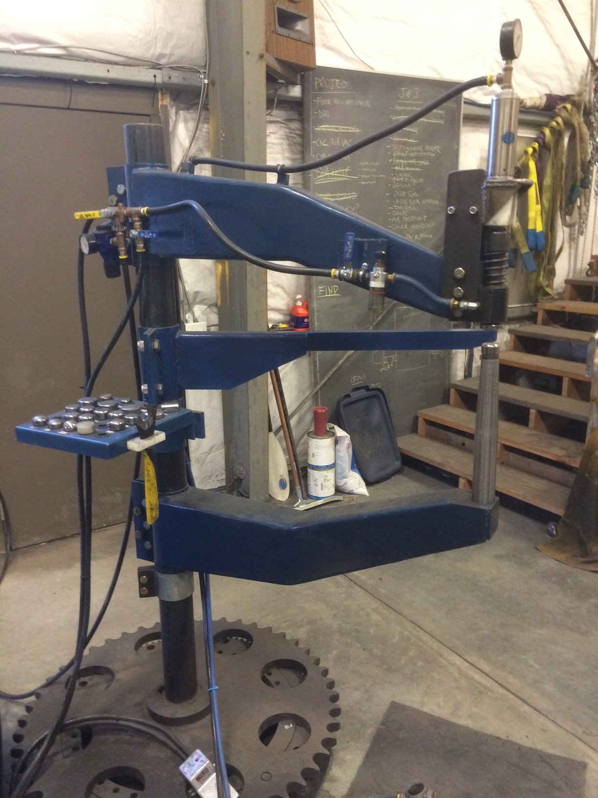 My custom-made planishing hammer. It was designed by myself and powered with a Michigan Pneumatic air motor and controlled with an pneumatic cylinder via a treadle valve from dump truck air brakes. It performes wonderfully.