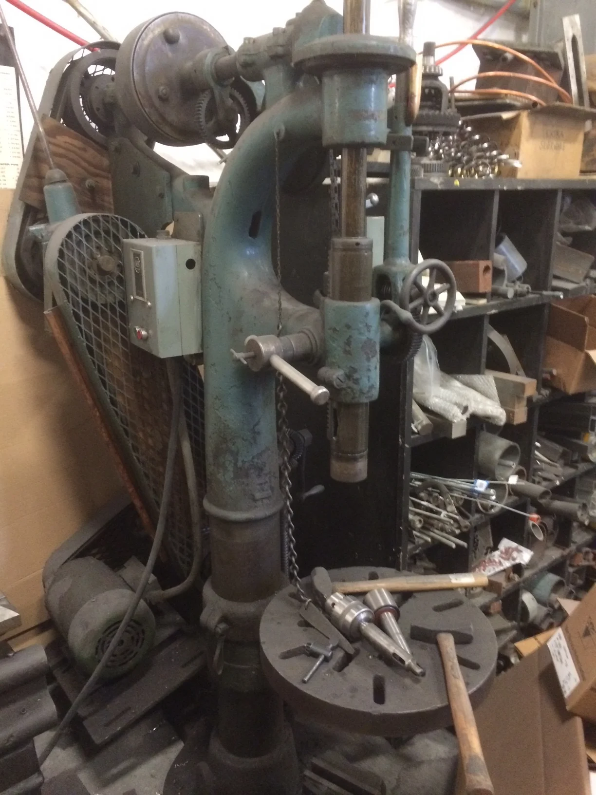 The drill press is also a classic. Formerly a flat overhead belt driven tool, it now has two stick shift transmissions and slows down to about 15 rpm and will make a 1" hole in 1" steel like a hot knife through butter.