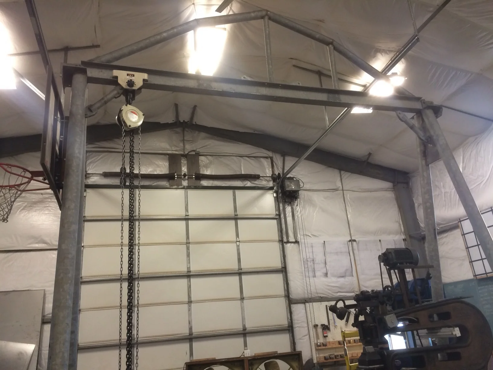 This is my home built gantry crane. It began life as a communications tower on Sheratin Mountain until it collapsed in a snow storm. A friend of mine ended up with the scrap and we picked out the parts to make this. I've lifted the 5,000 pound Pullmax with it. At 12' wide and 12' tall, you can drive right through it and pick freight out of the truck.