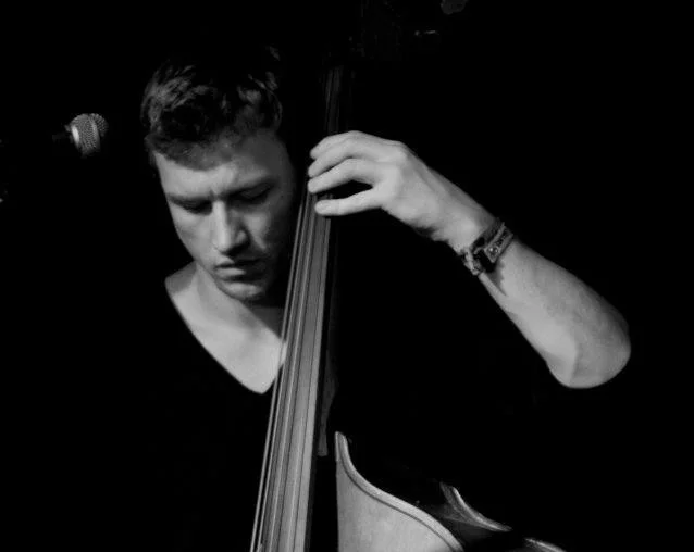 Chris Jones is a double and electric bassist currently residing in the South West. Chris studied jazz at the University of Exeter and the Birmingham Conservatoire where he had the privilege of studying and playing with some great musicians such as John Taylor, Stan Sulzmann, Mark Hodgson, Dave Holland, Hans Koller and Arnie Somogyi. Last year Chris toured extensively with the Bristol based dynamic, violin led quintet The People’s String Foundation