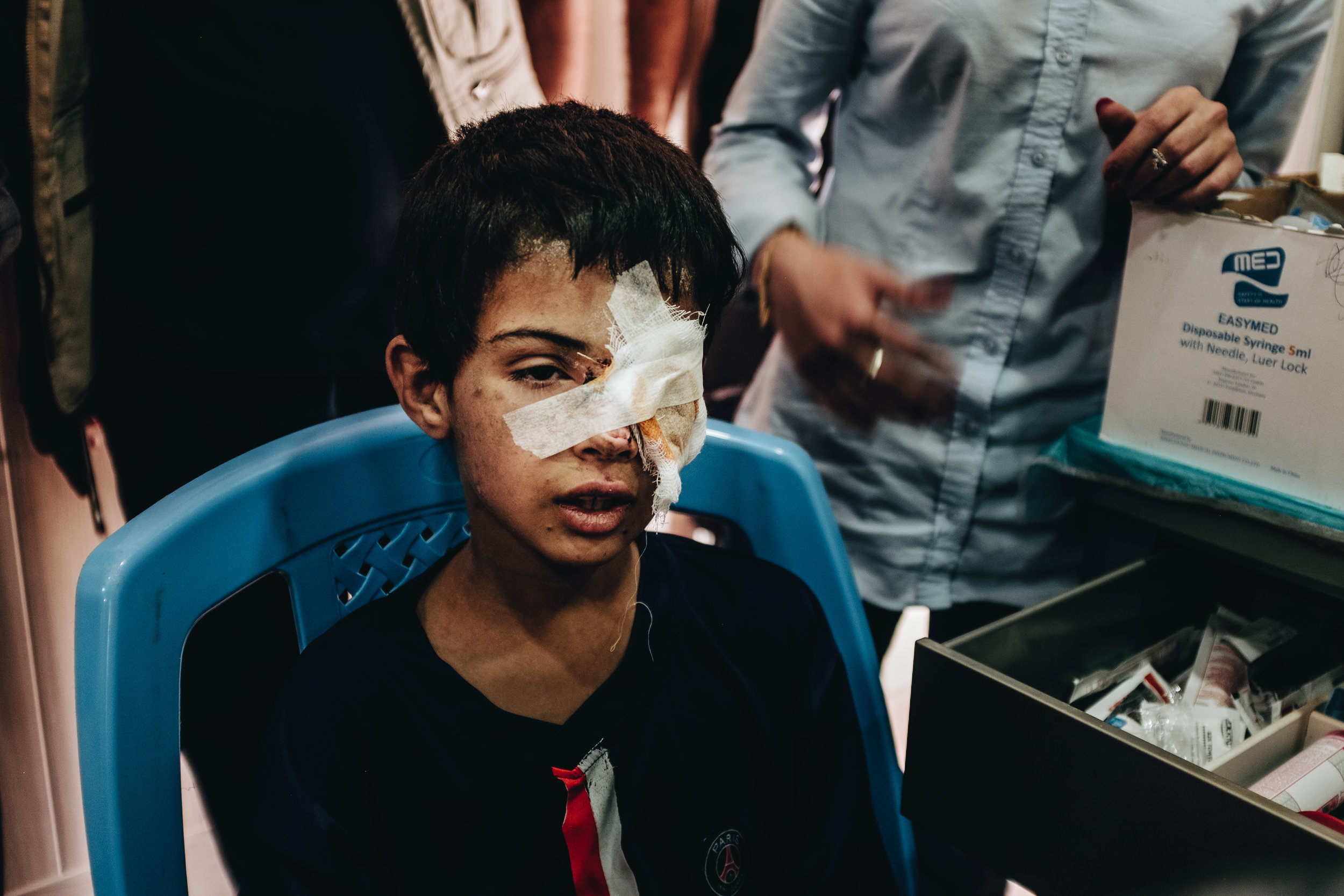 “We are not Daesh,” a mother pleads as she waits for her son’s wounds to be treated by a visiting volunteer doctor. “We just want to leave here.”