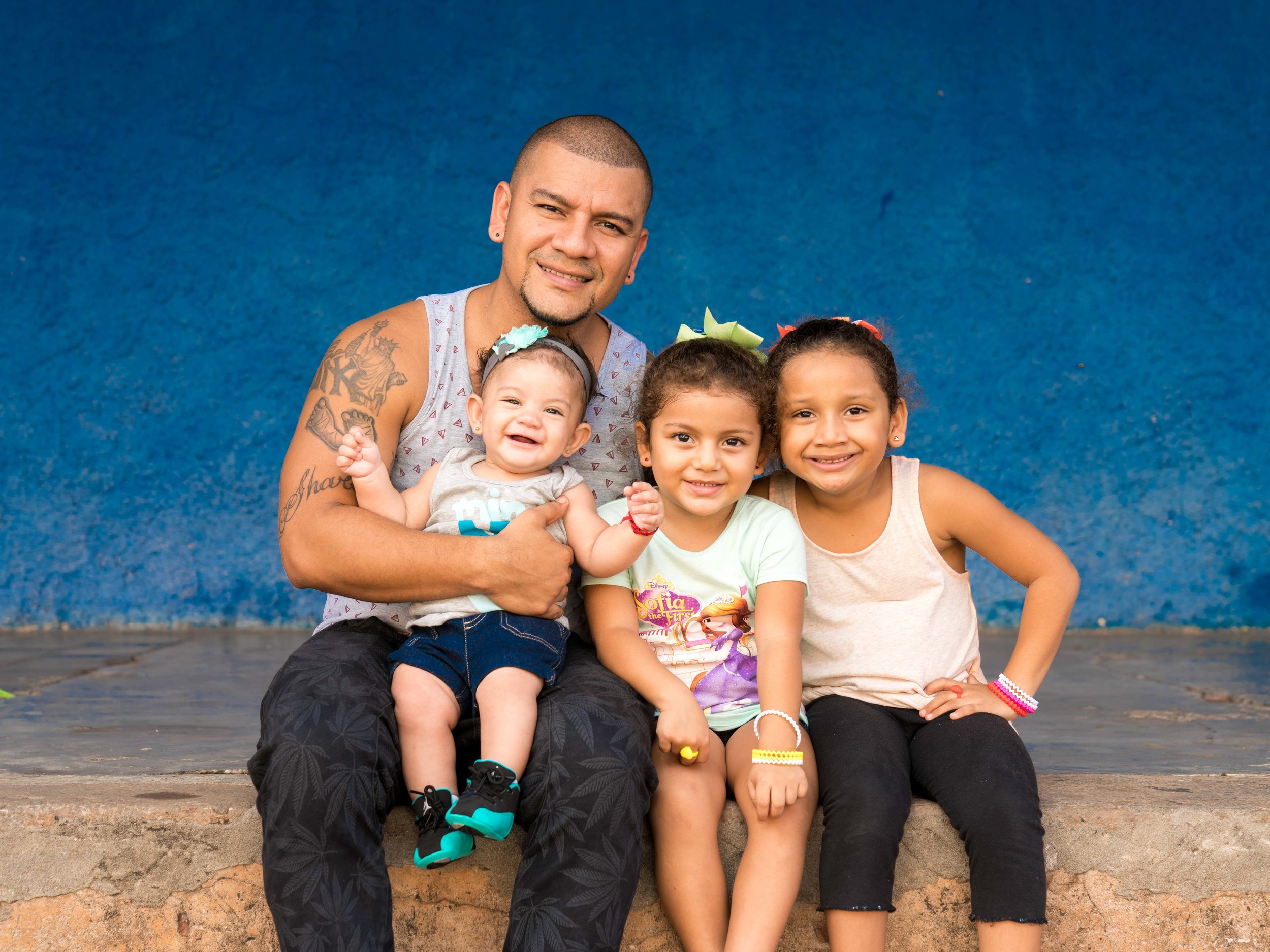 Orlando is a tough man, but as soon as he started talking about his girls (his eyes softened and he called them his little angels) I knew I had to make a portrait for them. Here he is with his girls Sharon, Emily and Jennifer.