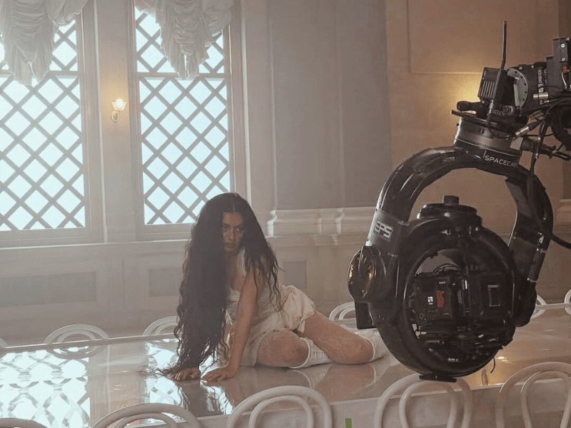 Charli_XCX_sitting_on_top_of_a_large_table-min.width-800.png
