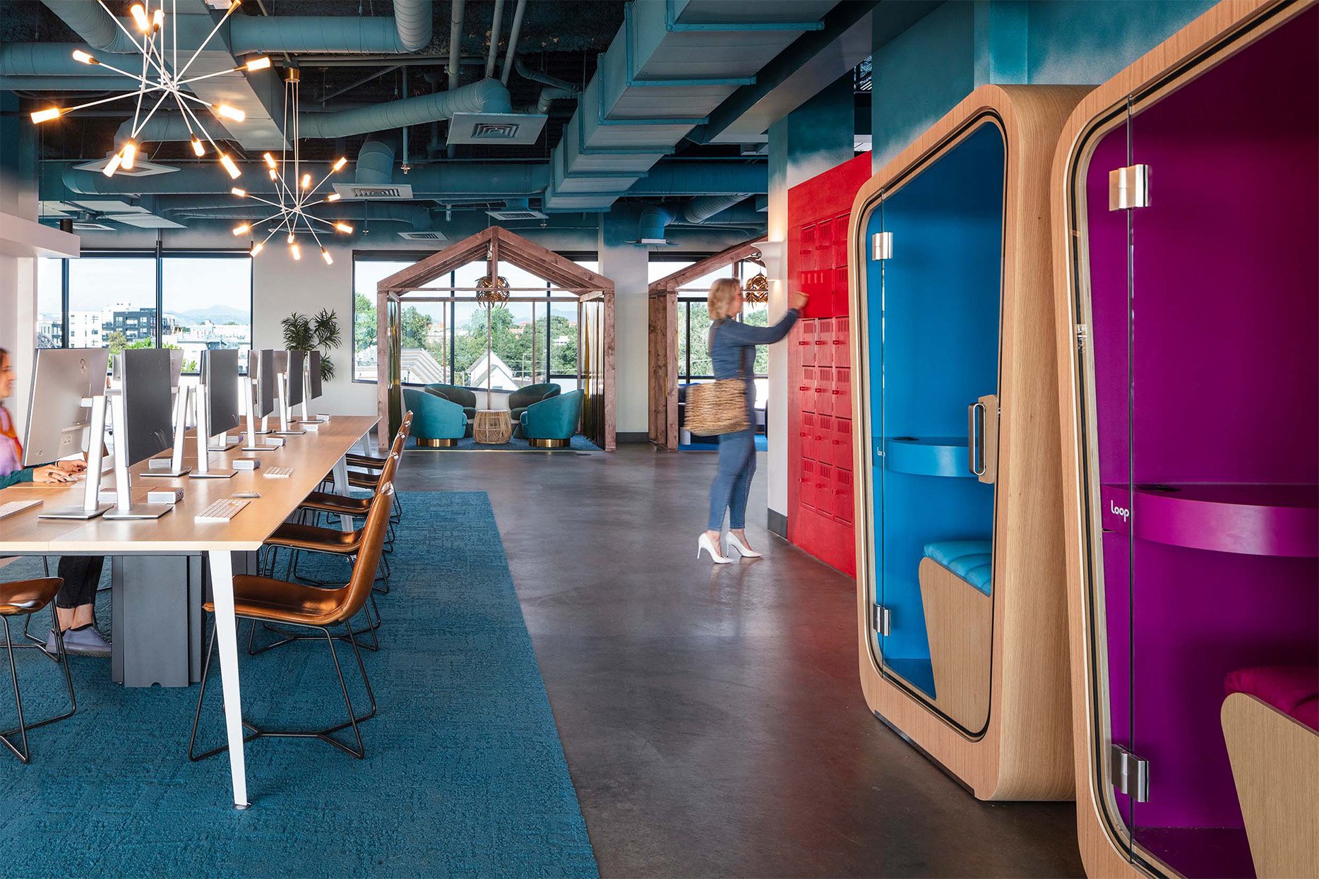 two-Loop-Solo-office-pods-with-vividly-colored-interiors-inside-a-very-colorful-open-office-space.jpg