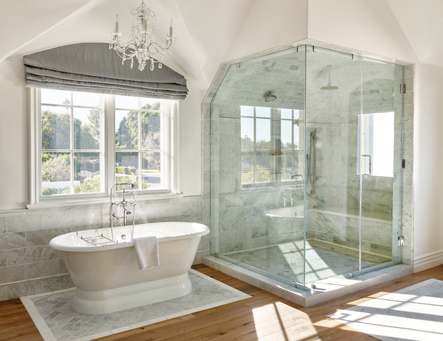 The muted grey’s in the Carrera marble along with grey linen shades create a soothing retreat.
