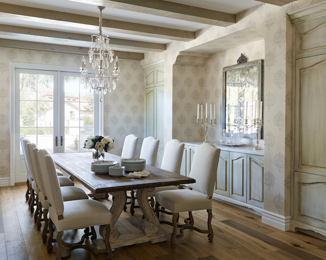The kitchen features Carrera marble with highlights of grey and the subtle sage cabinets have a grey wash over them. The lighting is custom made from Hinkley’s . 