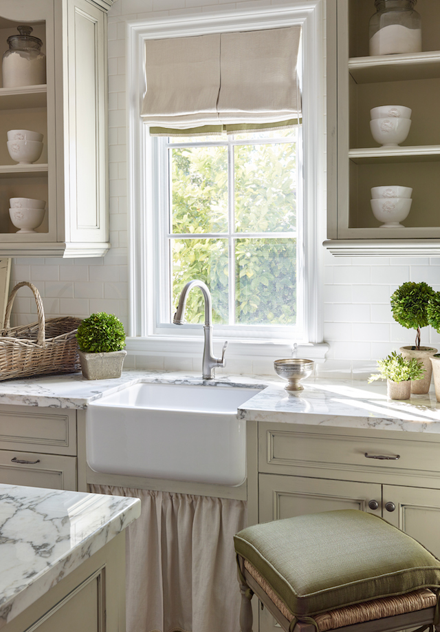 The powder room is painted a pale grey and features an antique Carrera basin from Relics .