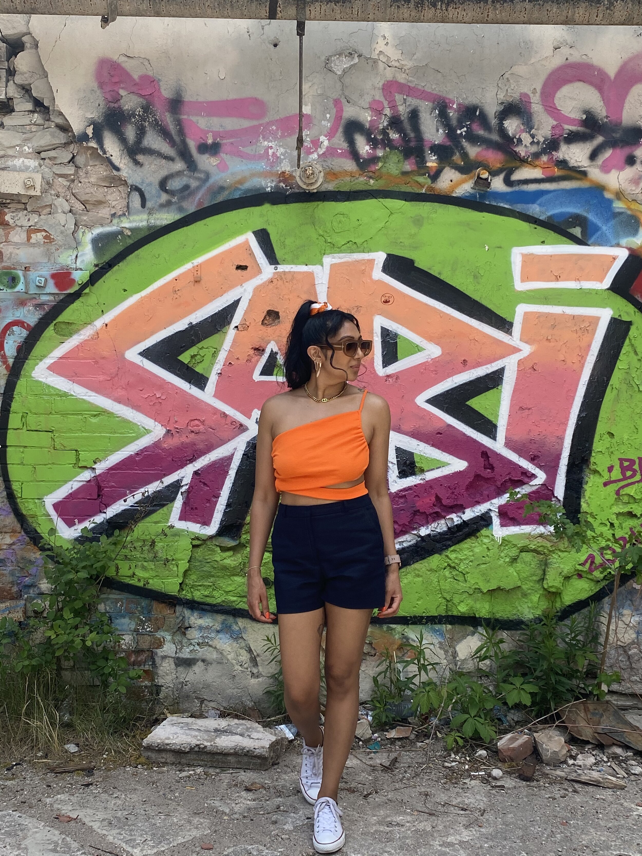 Dezi Backtrack Glasses and neon orange top