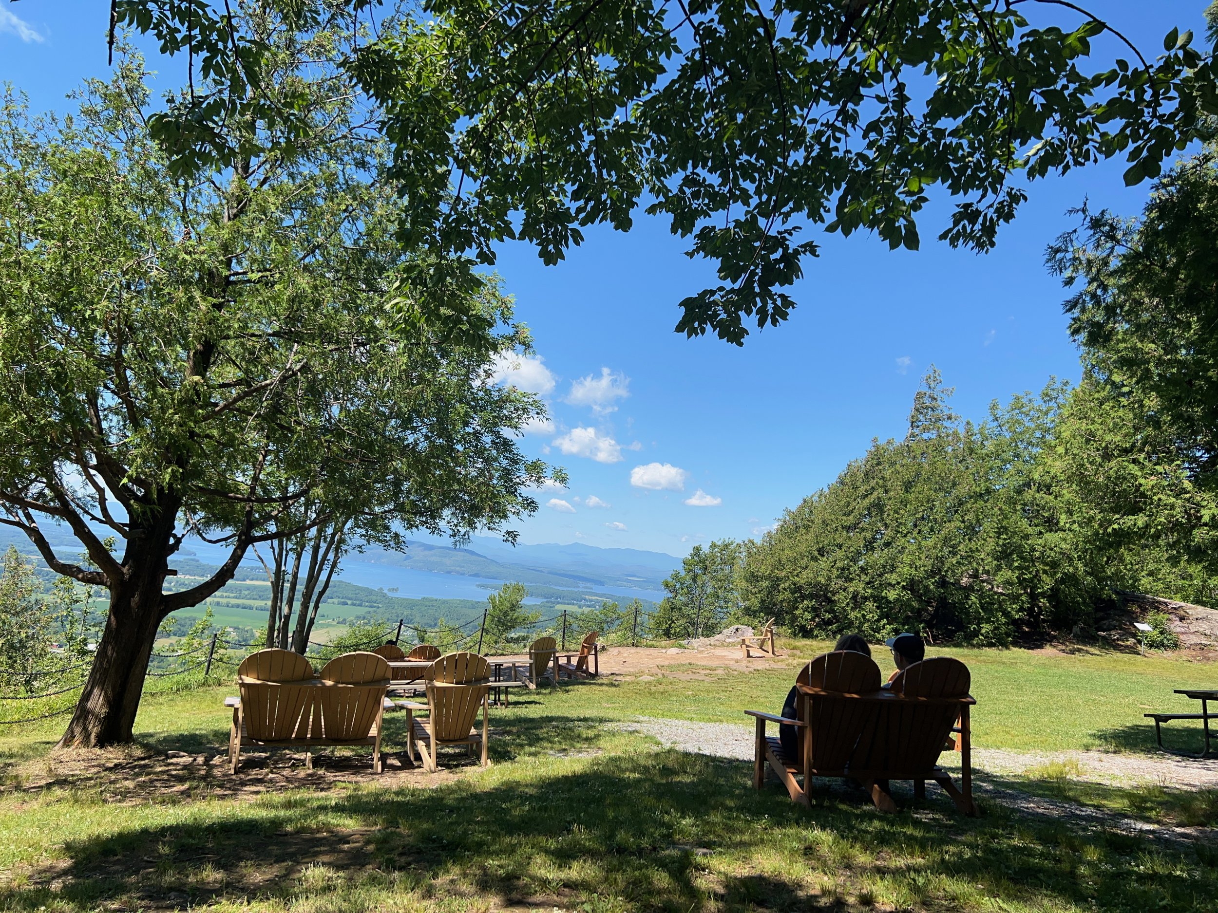 Sitting on Adirondack chairs overlooking the Adirondack Mountains