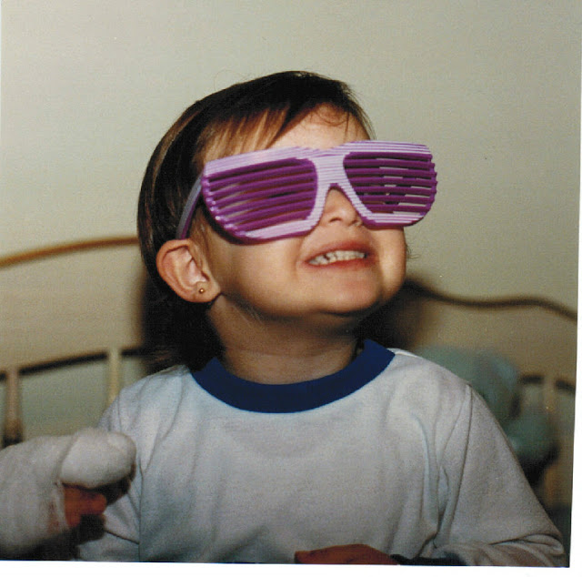 Accessories were an important addition from a very early age. As was my typical, cheesy grin. Life is best lived happily and in sunglasses!