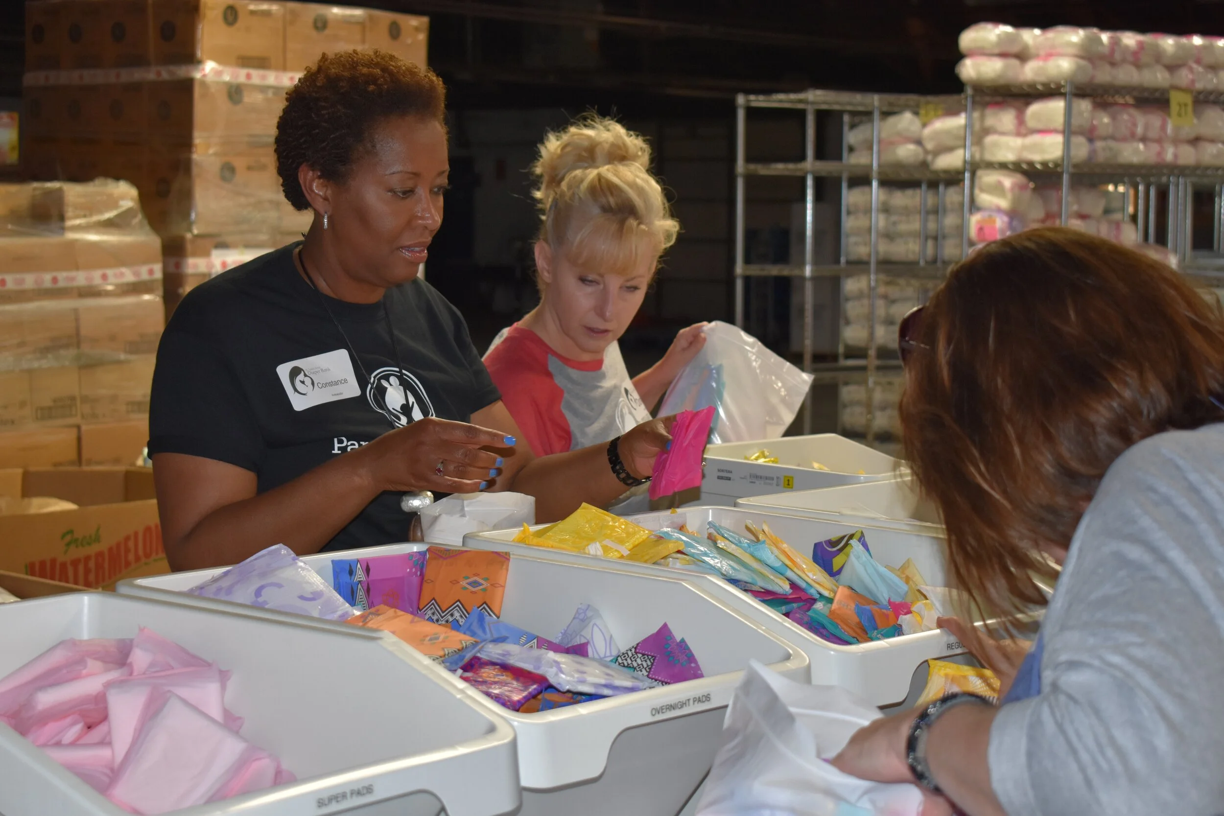 At left: Parents as Teachers President/CEO Constance Gully and Donna O’Brien VP, professional and program development, and Kerry Caverly, PAT senior VP, chief program officer, prepare feminine hygiene product kits for distribution to area low-income women at the St. Louis Diaper Bank as part of PAT’s giving back to the community initiative on the National Day of Service.